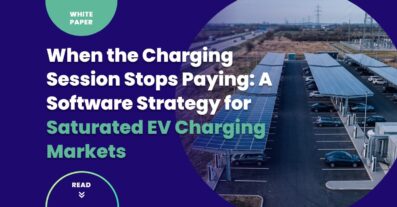 Aerial view of a large public EV charging plaza at dusk illustrating the saturated EV charging business model, with multiple charging bays connected to grid infrastructure