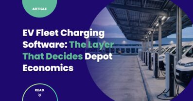 EV fleet charging software context — electric delivery vans charging in rows at a dawn logistics depot with canopy solar, no people, no visible brands